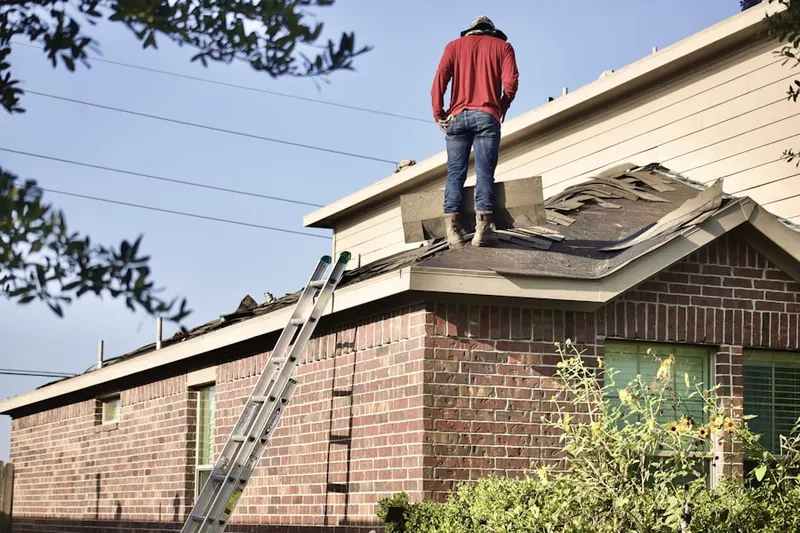 Professional roofer working on a residential roof in North Victory